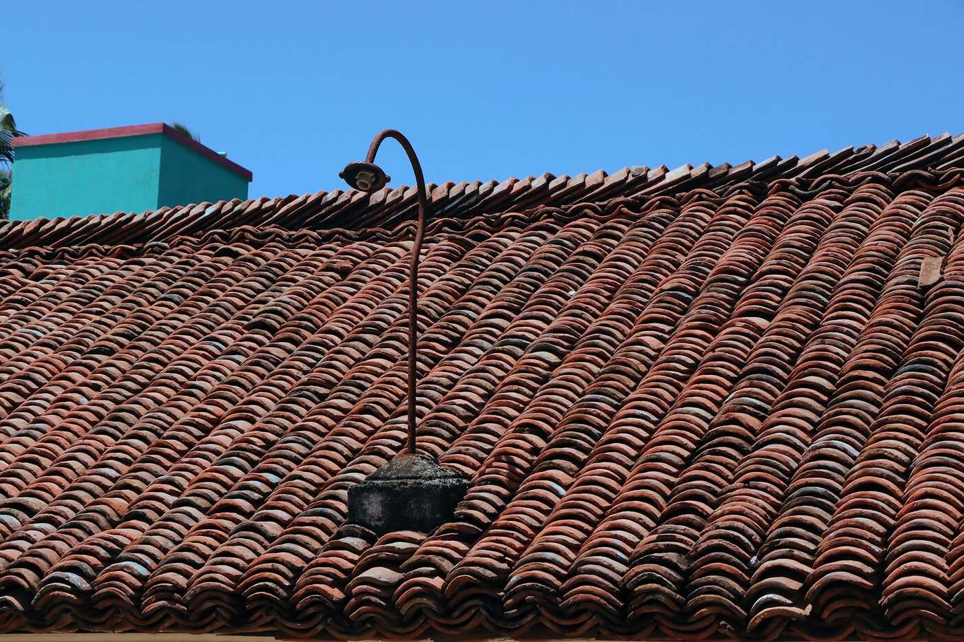 Close view of a barrel tile roof at the eave course, where the bird stop closes the gap