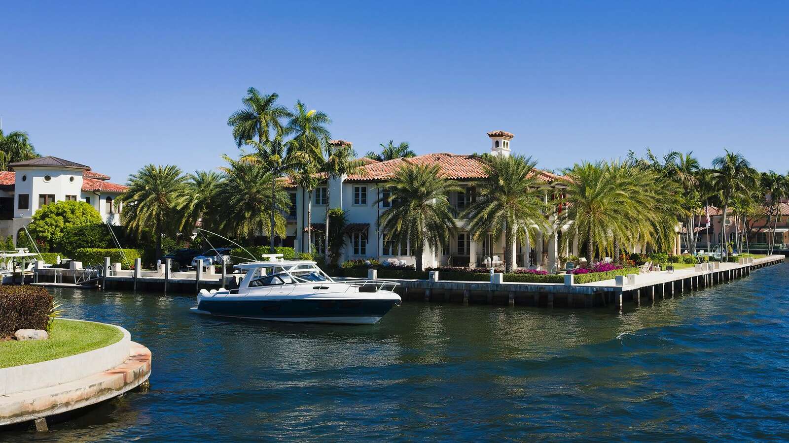 Canal-front houses with docks and sea walls in Fort Lauderdale, seen from the water