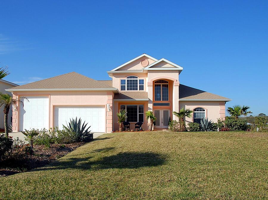 A single-story Florida house with a tile roof and palms, the kind that changes hands with a clearance letter