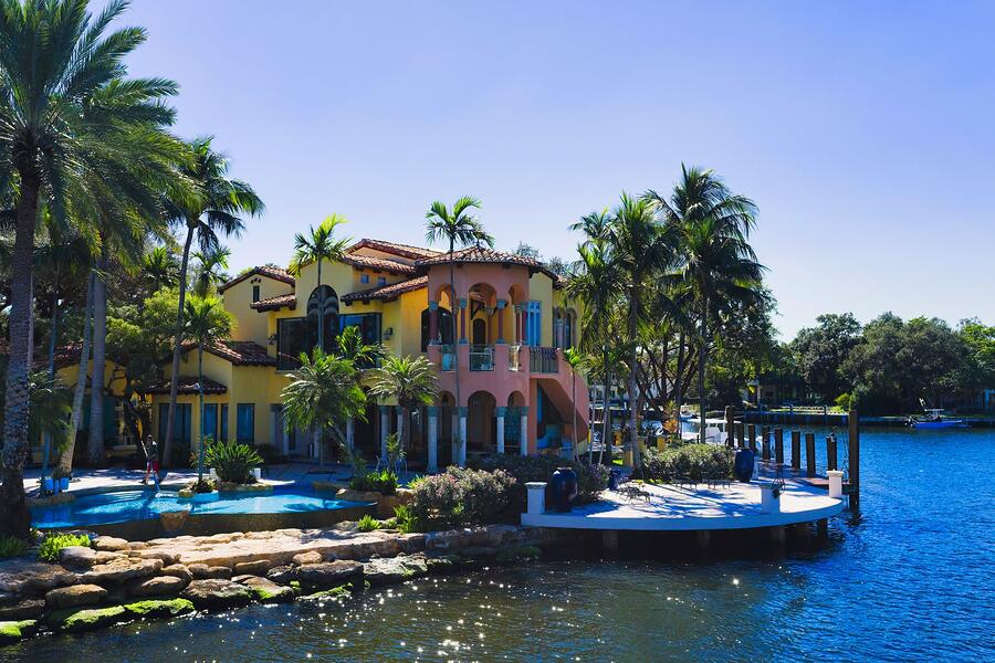 A Mediterranean Revival house with a barrel tile roof and arched windows