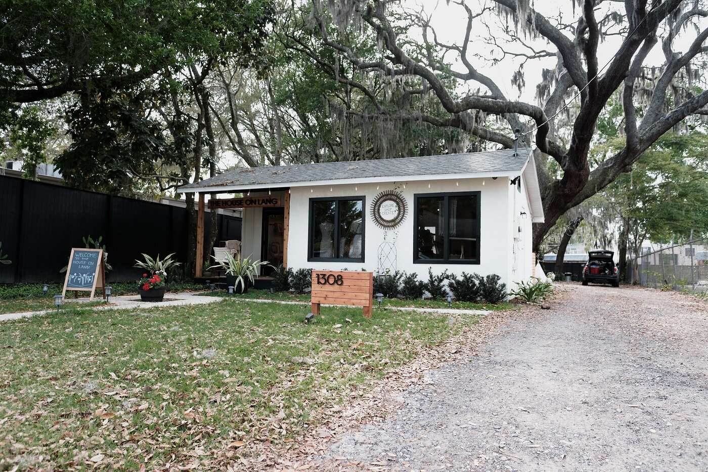 A 1960s ranch house under heavy tree canopy