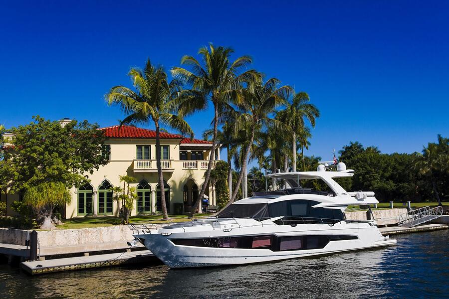 A yacht moored at the private dock behind a canal-front Fort Lauderdale house